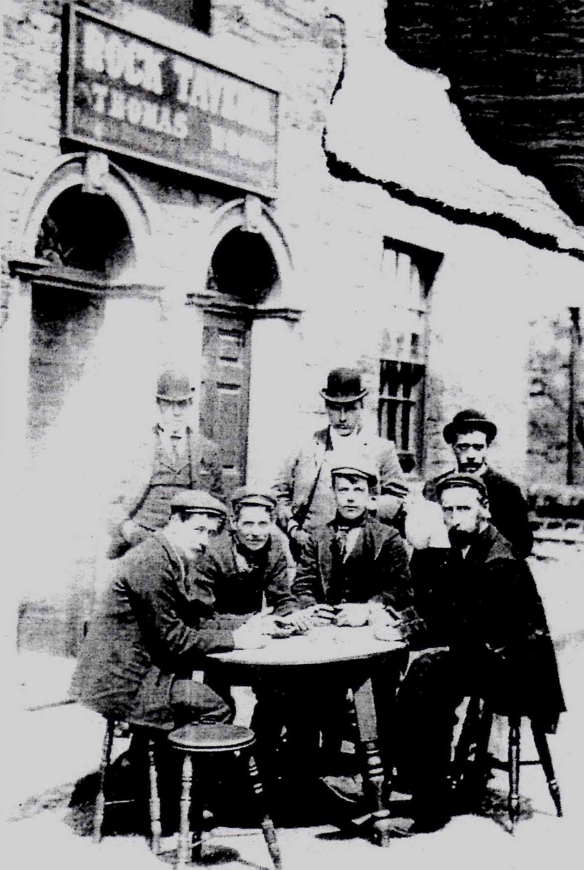 Thomas Wood (standing centre) with his sons either side and seated customers.